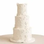 Elegant Three-Tier White Floral Wedding Cake.